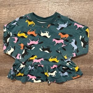 Hanna Andersson Long Sleeve Peplum Top in “Gallop” Print on Dark Green